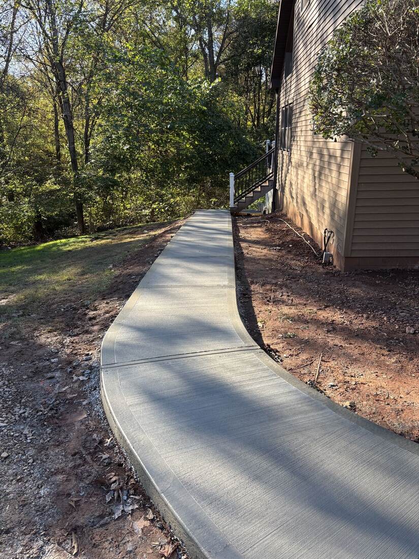Concrete walkway alongside custom home